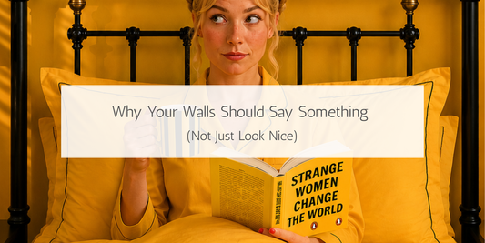 Woman in yellow pyjamas reading in bed beneath a colourful abstract art print, illustrating how meaningful wall art can add personality and expression to a home.