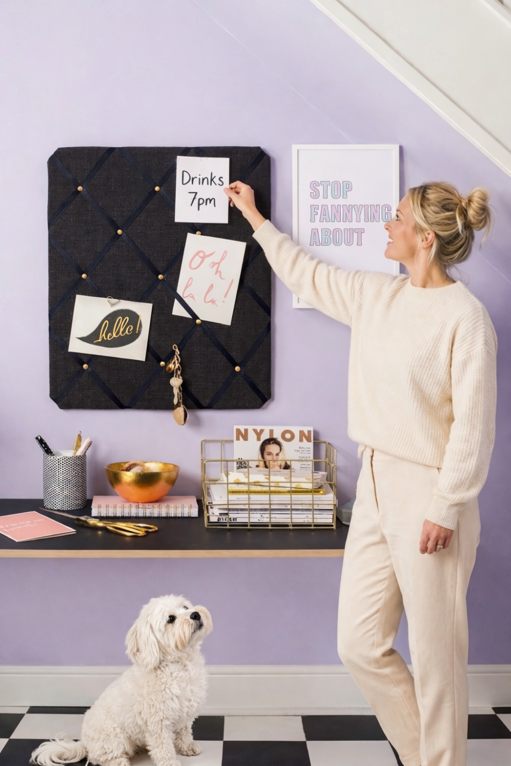 Calm hallway organisation setup with a fabric notice board holding reminders and notes, styled above a console table with storage, showing a simple system for managing post and everyday life