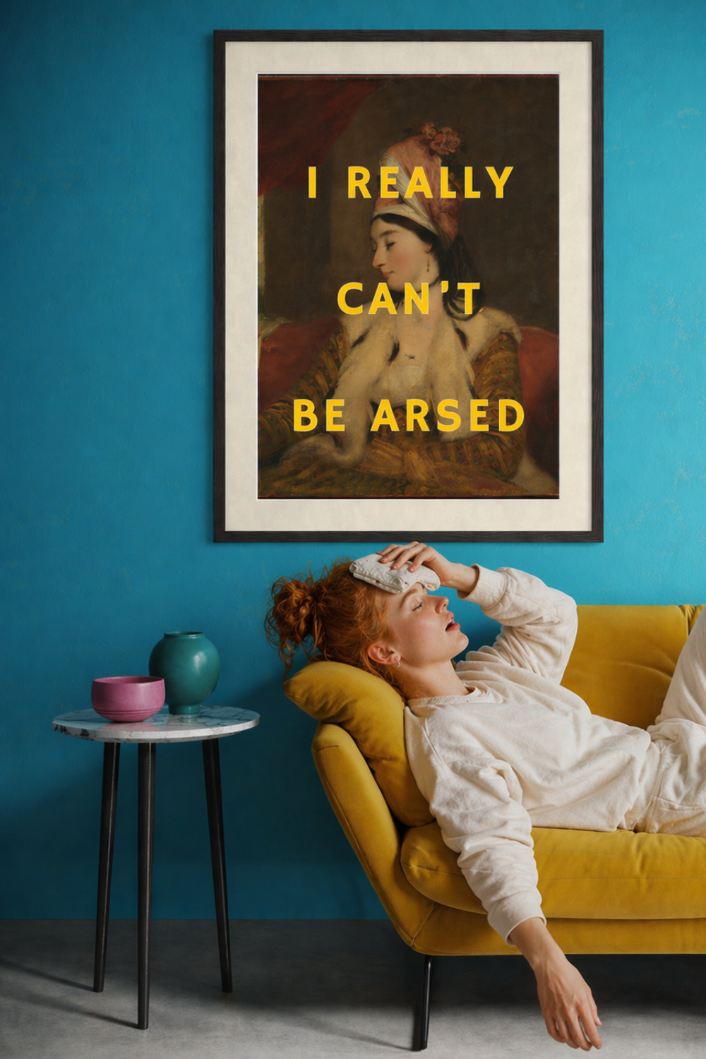 Altered classical art print with bold text “I Really Can’t Be Arsed” in a colourful modern interior with a relaxed woman on a chair