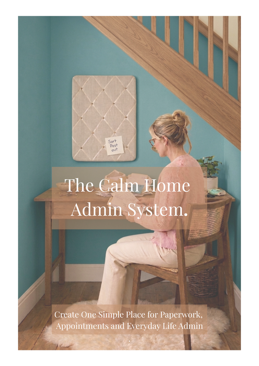 Cover of The Calm Home Admin System digital guide showing a woman sorting paperwork beneath an understairs workspace with a fabric notice board, creating one simple place for paperwork, appointments and everyday life admin.